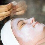 esthetician-prepping-clients-skin-for-microdermabrasion