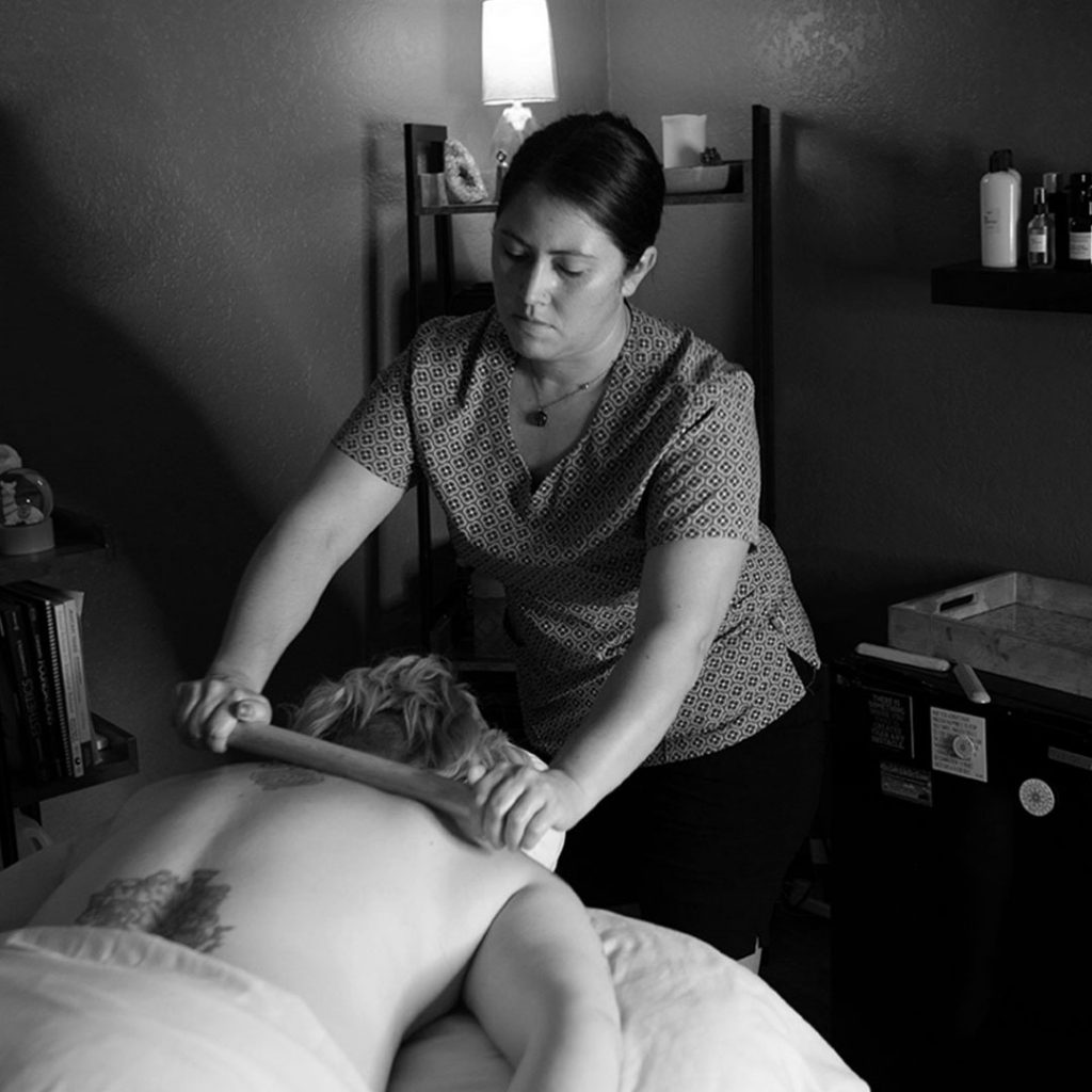 massage therapist doing a hot bamboo massage in Springfield, MO at Precision Wellness