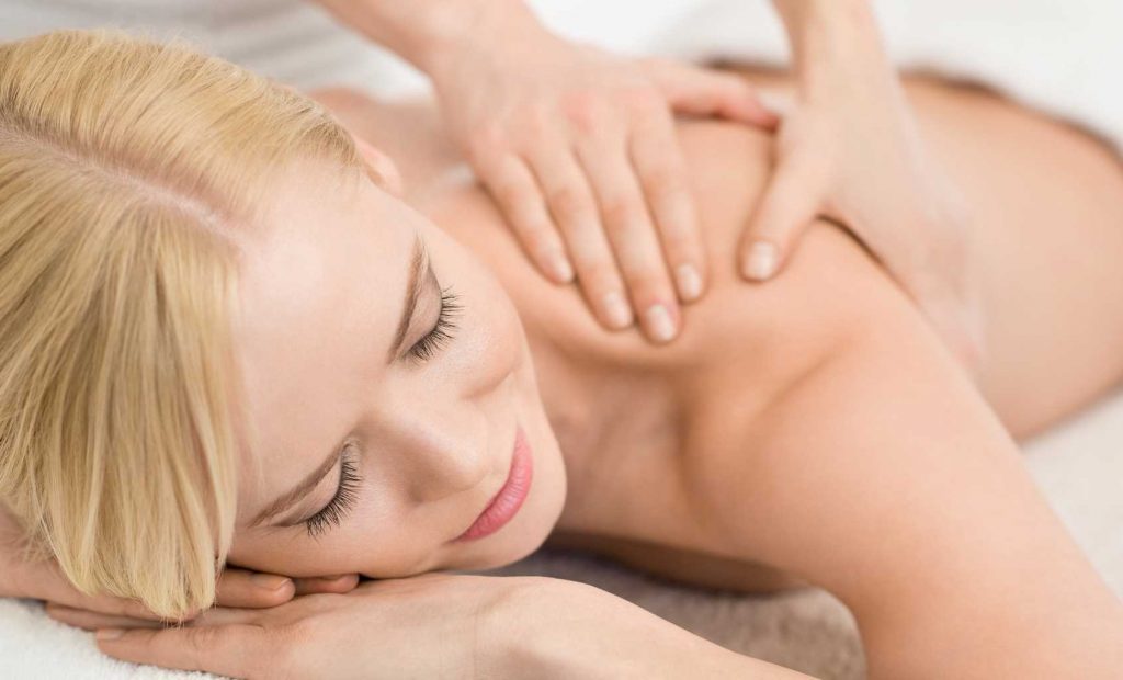 therapeutic blond woman shoulder massaged